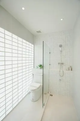 a white bathroom with a toilet and a shower at I-Zen Residence Central Eastville in Bangkok