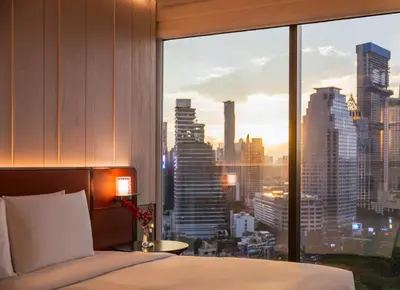 a bedroom with a large window with a city view at Andaz One Bangkok in Bangkok