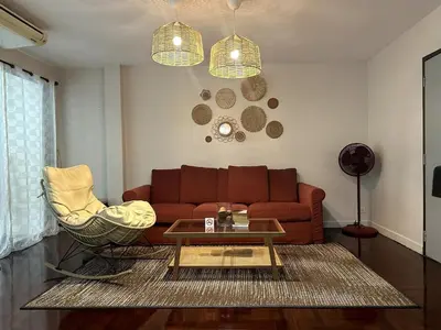 a living room with a couch and a coffee table at Delightful Townhouse in the Heart of Sukhumvit in Bangkok