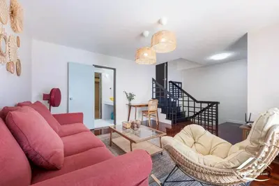 a living room with a red couch and chairs at Delightful Townhouse in the Heart of Sukhumvit in Bangkok