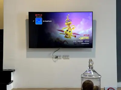 a flat screen tv hanging on a wall at Delightful Townhouse in the Heart of Sukhumvit in Bangkok