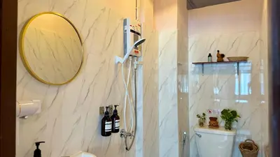 a bathroom with a shower with a mirror and a toilet at Baan YentaFo - Pink House in Talad Noi in Chinatown