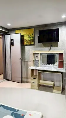 a room with a desk with a television and a door at โรงแรม เลิฟ บีเคเค in Amphoe Phra Khanong