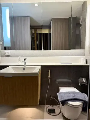 a bathroom with a sink and a toilet and a mirror at Cozy room in Sukumvit in Bangkok