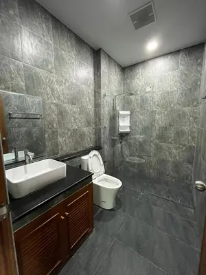 a bathroom with a sink and a toilet and a shower at Cozy Corner in Samut Prakan