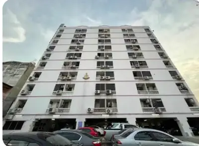 a tall white building with cars parked in front of it at Old Town cozy corner in Thonhuri