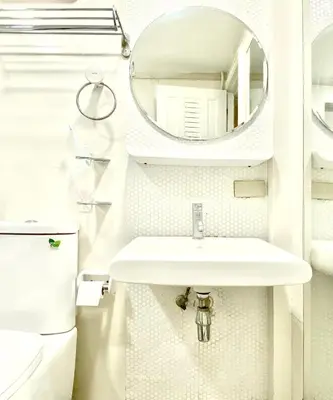 a white bathroom with a sink and a mirror at AkkHouse in Ban Bang Toei (1)