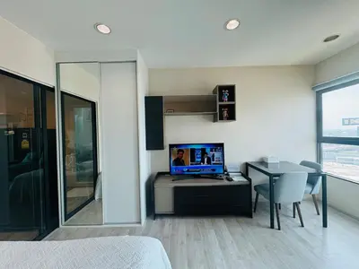 a bedroom with a bed and a desk with a computer at ห้องพัก แบบ Studio ติดเซ็นทรัลเวสเกต in Ban Bang Krabu