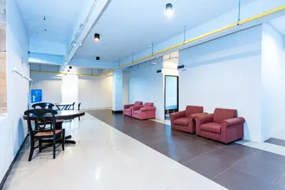a conference room with red chairs and a table at XX The Hidden Khaosan Road Bangkok in Bang Bua Thong Railway Station