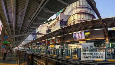 a building with a train on the tracks at Executive 1 BR and Sofa bed Next to T21 Asoke BTS in Bangkok