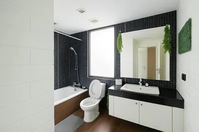 a bathroom with a toilet and a sink and a mirror at Modern 2 Bed Executive Unit 5min to Nana BTS in Bangkok