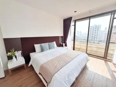 a bedroom with a large bed and a large window at Nana SkyView Retreat 2 Bedroom 2 Bath Nana BTS in Bangkok