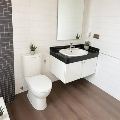 a white bathroom with a toilet and a sink at Nana SkyView Retreat 2 Bedroom 2 Bath Nana BTS in Bangkok