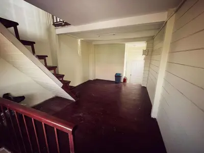 an empty hallway with stairs and a door at Happy Hope Khao San in Bangkok