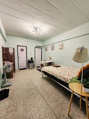 a bedroom with a bed and a table in it at 704-STP Homely room Free Wi-Fi and Near BTS in Bangkok