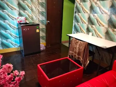 a room with a table and a red box on the floor at A fantastic house next to W district food market in Amphoe Phra Khanong