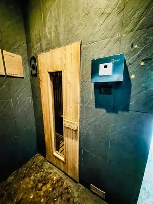 a small door in a wall with a box at Downtown, Cozy 1BR, 48sqm, Middle of ThongLo, High Floor, Pool, Gym, Fast Wifi in Bangkok