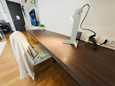 a wooden desk with a lamp on top of it at Downtown, Cozy 1BR, 48sqm, Middle of ThongLo, High Floor, Pool, Gym, Fast Wifi in Bangkok