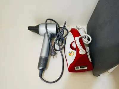 a hairdryer and a hair dryer and a blow dryer at Downtown, Cozy 1BR, 48sqm, Middle of ThongLo, High Floor, Pool, Gym, Fast Wifi in Bangkok