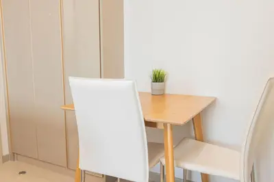 a small table and chairs with a plant on it at KINGbed with Pool Gym and Standing Desk near MRT in Bangkok