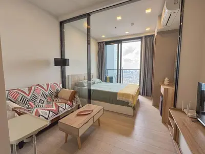 a hotel room with a bed and a couch at 47fl Skyview with Balcony Pool Gym 200m from MRT in Bangkok
