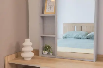 a mirror reflecting a bedroom with a bed in it at 47fl Skyview with Balcony Pool Gym 200m from MRT in Bangkok