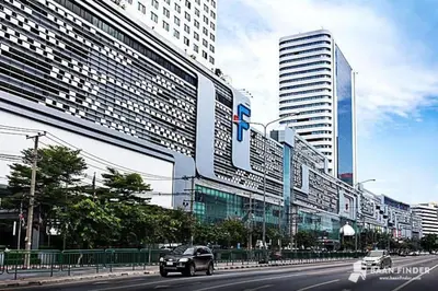 a car driving down a city street with tall buildings at High Skyview Studio with Desk Pool Gym MRT 200m in Ban Na Song