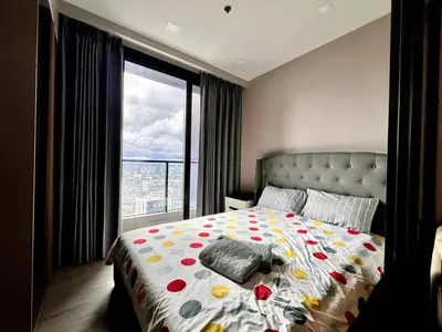 a bedroom with a bed with a large window at 52nd Fl Apt with Desk Pool and Gym MRT 200m Away in Ban Na Song