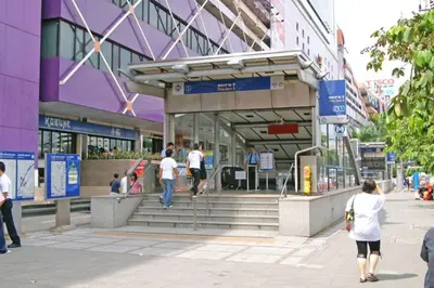 a group of people walking in front of a building at 52nd Fl Apt with Desk Pool and Gym MRT 200m Away in Ban Na Song