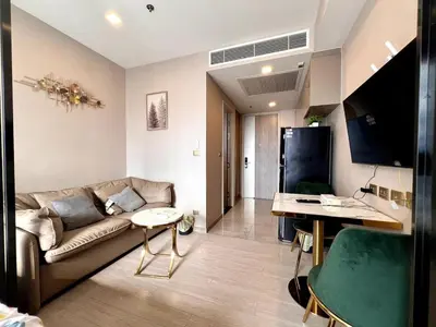 a living room with a couch and a table at 52nd Fl Apt with Desk Pool and Gym MRT 200m Away in Ban Na Song