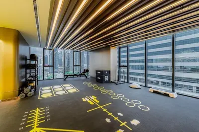 a gym in a building with large windows at Free Parking with Balcony Pool and Gym MRT 200m in Ban Na Song