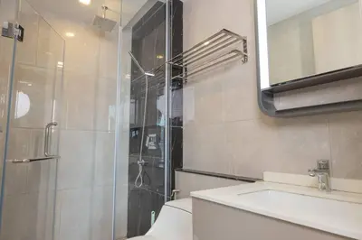 a bathroom with a shower and a toilet and a sink at 40th Fl Skyview with Standing Desk Pool and Gym in Ban Na Song
