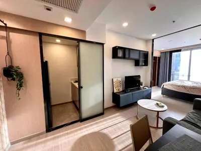 a room with a bed and a living room with a couch at King Bed with Living Room Pool and Gym MRT 200m in Ban Na Song