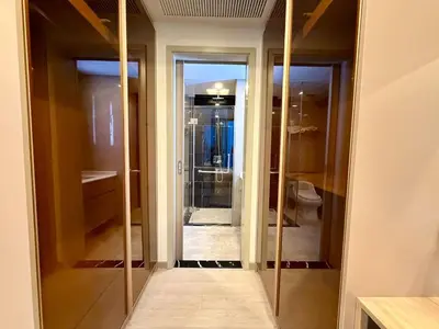 a bathroom with a walk in closet with glass doors at Peak Luxury Living with King Bed Golf Pool and Gym in Ban Na Song