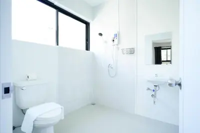 a white bathroom with a toilet and a sink at XX Snap inn Sukhumvit 1 สแนป สุขุมวิท ซอย 1 in Makkasan