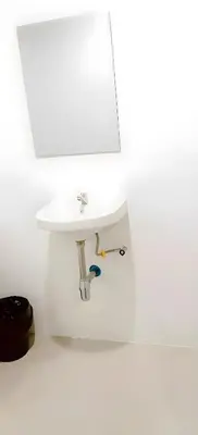a white sink in a bathroom with a mirror at xx Snap Inn Sukhumvit 1 - สแนป อินน์ สุขุมวิท 1 in Makkasan