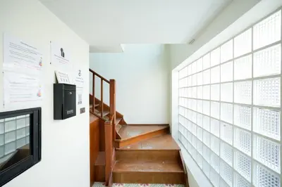 a staircase in a house with a television and a stair case at xx Snap Inn Sukhumvit 1 - สแนป อินน์ สุขุมวิท 1 in Makkasan