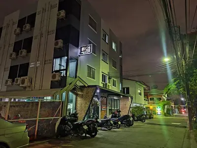 a group of motorcycles parked outside of a building at night at Irich Theparak S207- Bts-Chang Erawan 2kms in Ban Khlong Hua Sakae
