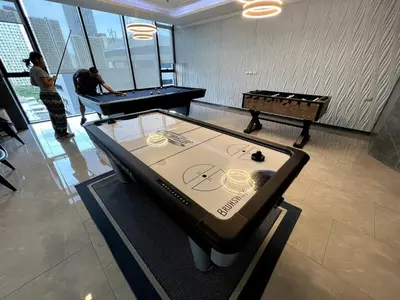 two people playing a game of pool in a room at Free Parking with Balcony Pool and Gym MRT 200m in Ban Na Song