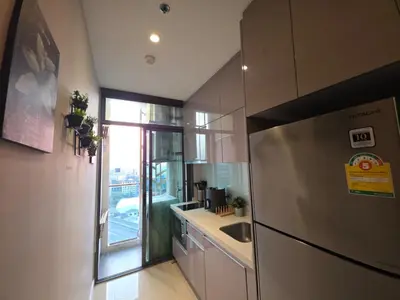 a kitchen with a stainless steel refrigerator and a sink at Mayfair Bangkok in Bangkok