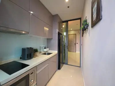 a kitchen with a sink and a counter top at Mayfair Bangkok in Bangkok