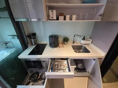 a small kitchen with a sink and a stove at Mayfair Bangkok in Bangkok