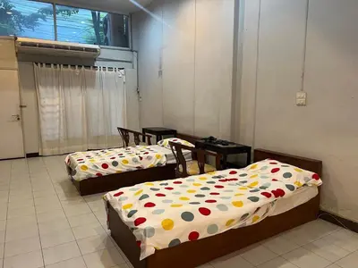 three beds with polka dot sheets in a room at Niche Space Sripraya- Samyan in Bangkok