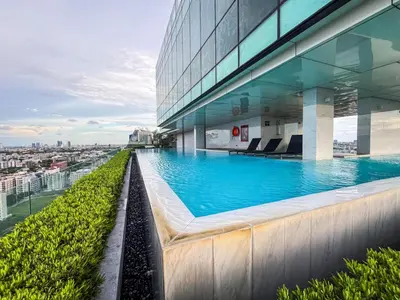 a swimming pool on the roof of a building at Near BTS Bearing l Rooftop pool and gym in Bangkok