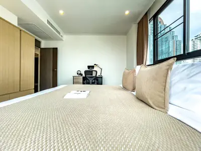 a bedroom with a large bed with a large window at Near BTS l Large 85 sqm l Rooftop Pool l Sontana in Bangkok