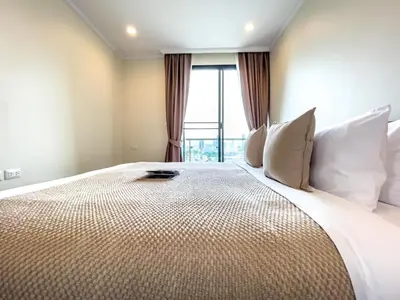 a bedroom with a large bed with a large window at Near BTS l Large 85 sqm l Rooftop Pool l Sontana in Bangkok