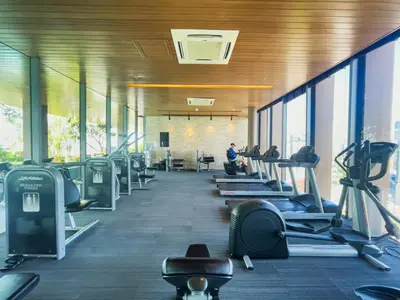 a gym with a row of treadmills and people on machines at 500m to BTS l Large 50 sqm l Workspace l By Sontana in Bangkok