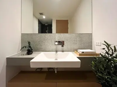 a bathroom with a white sink and a mirror at 500m to BTS l Large 50 sqm l Workspace l By Sontana in Bangkok