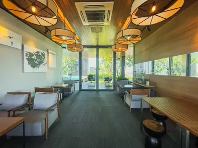 a restaurant with tables and chairs and windows at 500m to BTS l Large 50 sqm l Workspace l By Sontana in Bangkok