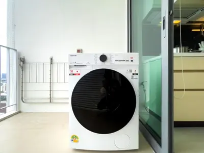 a washing machine with its door open in a room at Near BTS l Central Sukhumvit l Pool and Garden l Sontana in Bangkok